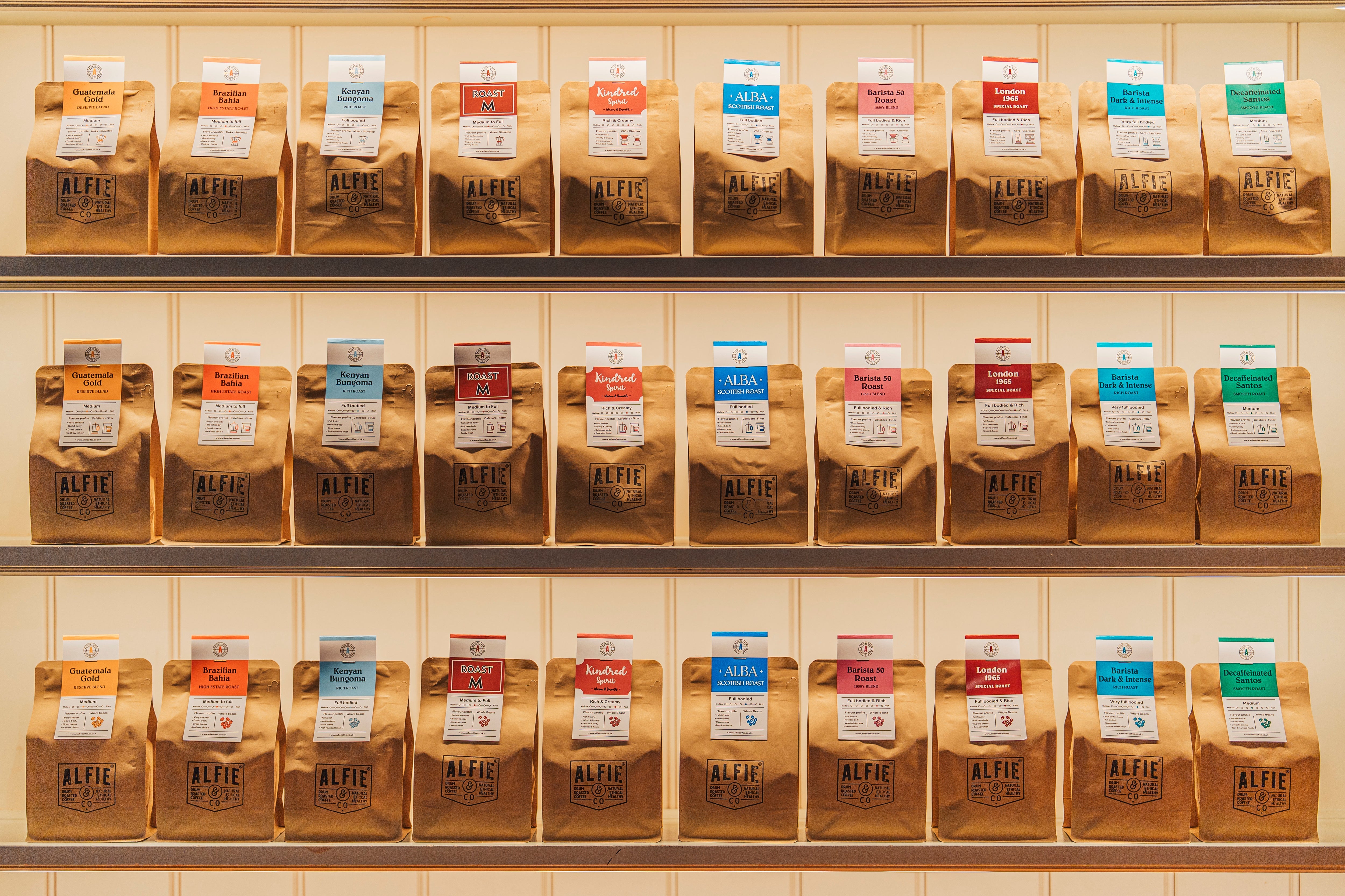 Display of 10 coffee bags labeled with brand names and roast levels